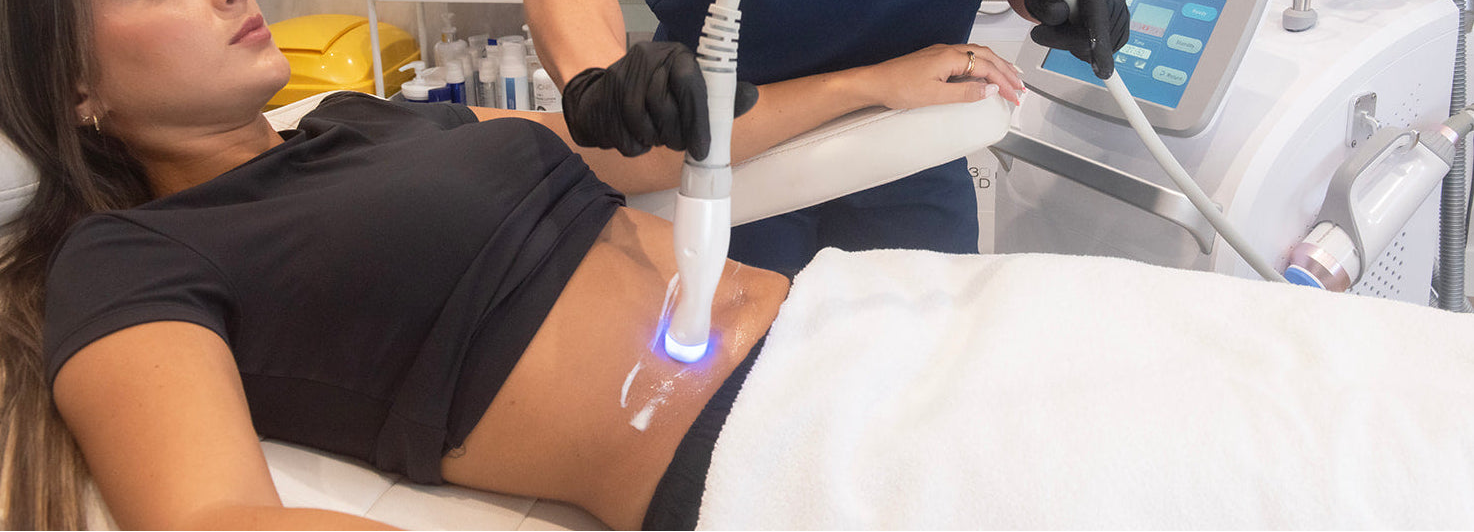 Woman receiving treatment on her abdomen in a clinical setting.