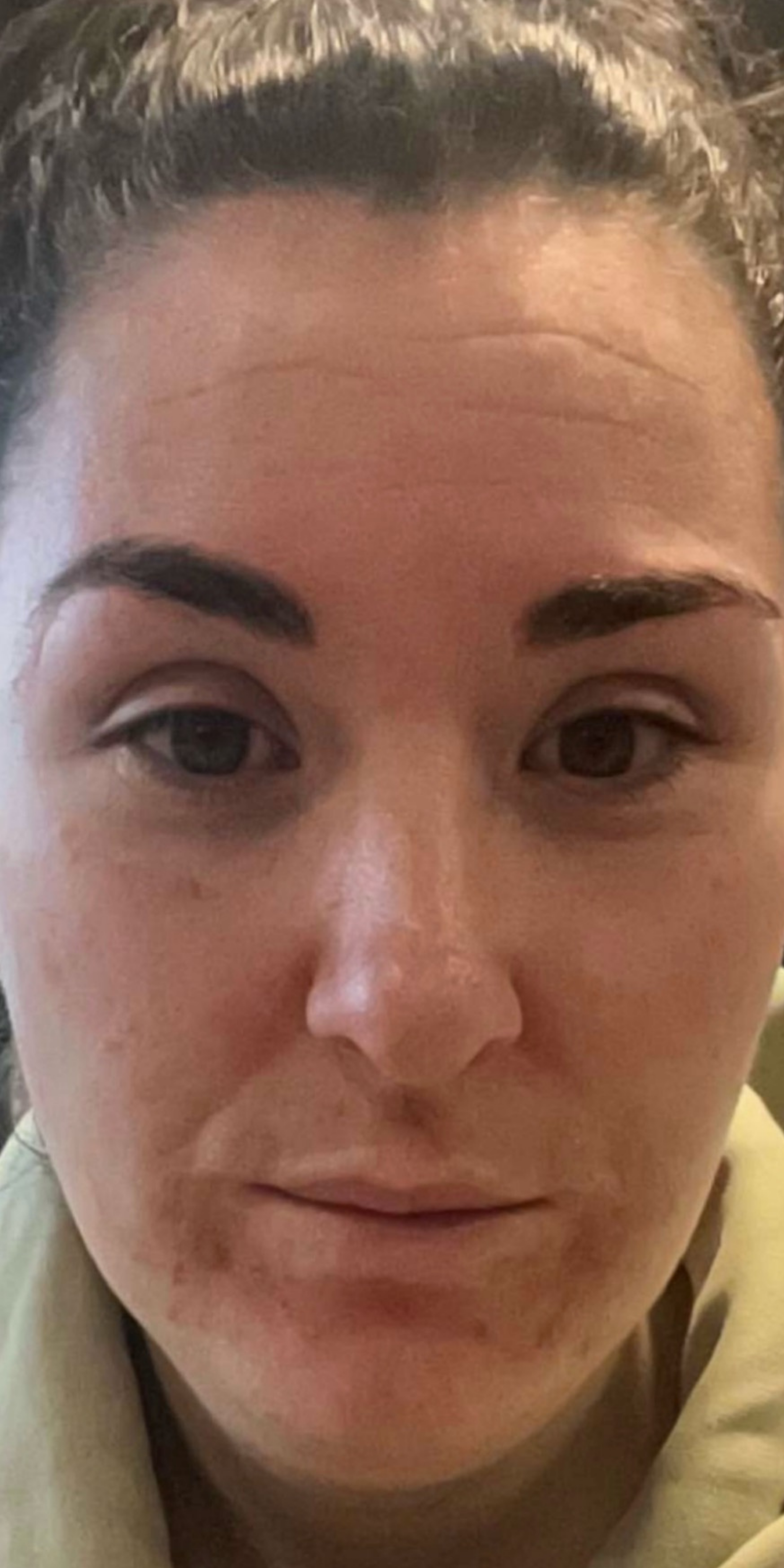 Close-up of a person's face with a neutral expression.