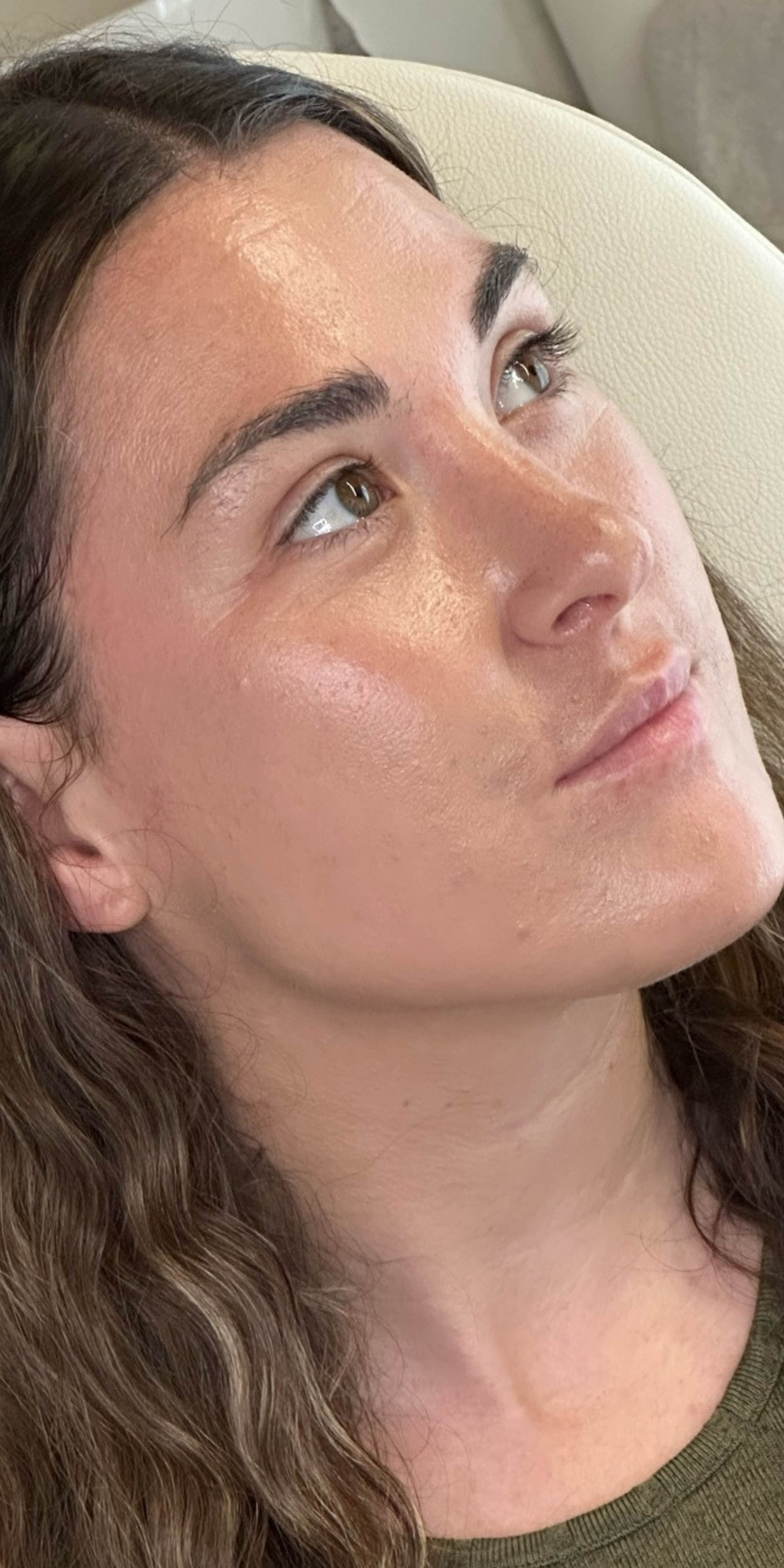 Close-up of a woman's face with a neutral expression, looking slightly to the side.