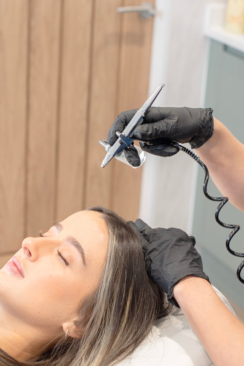 Person receiving cryotherapy treatment with a device on a blurred background