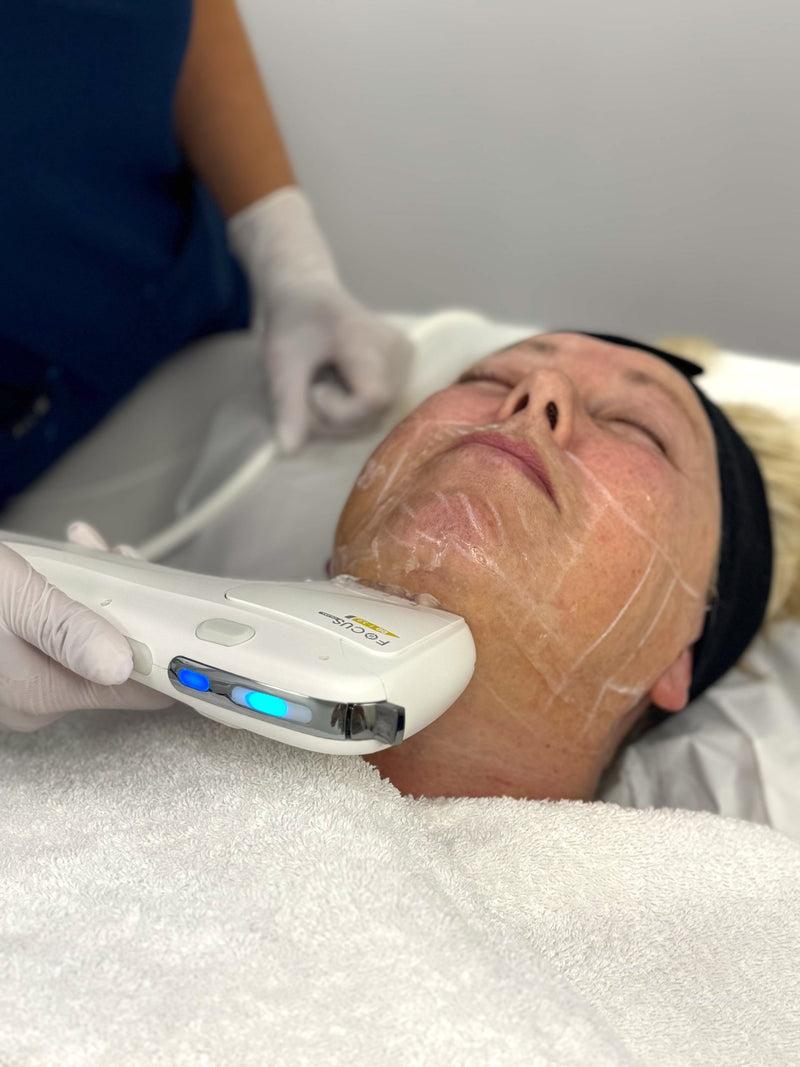 Person receiving a facial treatment with a device on their face.
